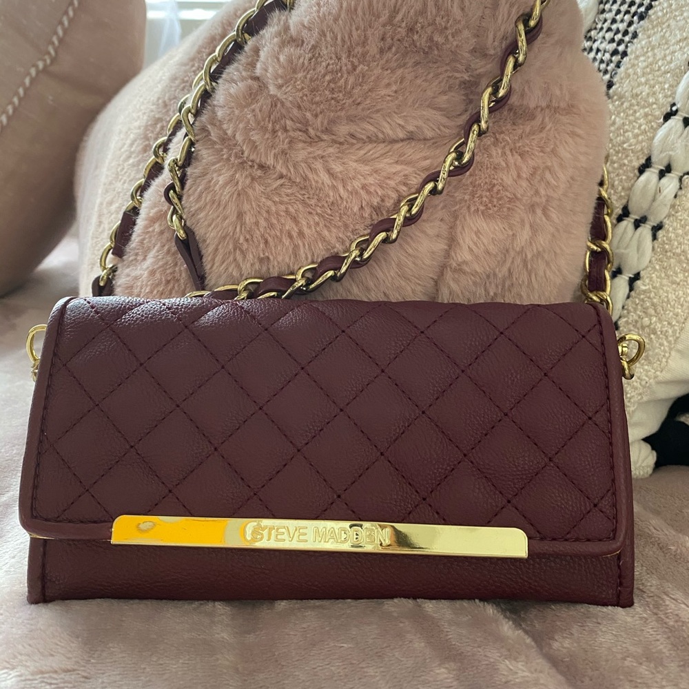 A maroon STEVE MADDEN Clutch bag